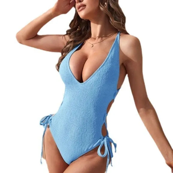 Women's black hollow backless tether one-piece swimsuit on a mannequin, showing sleeveless design.