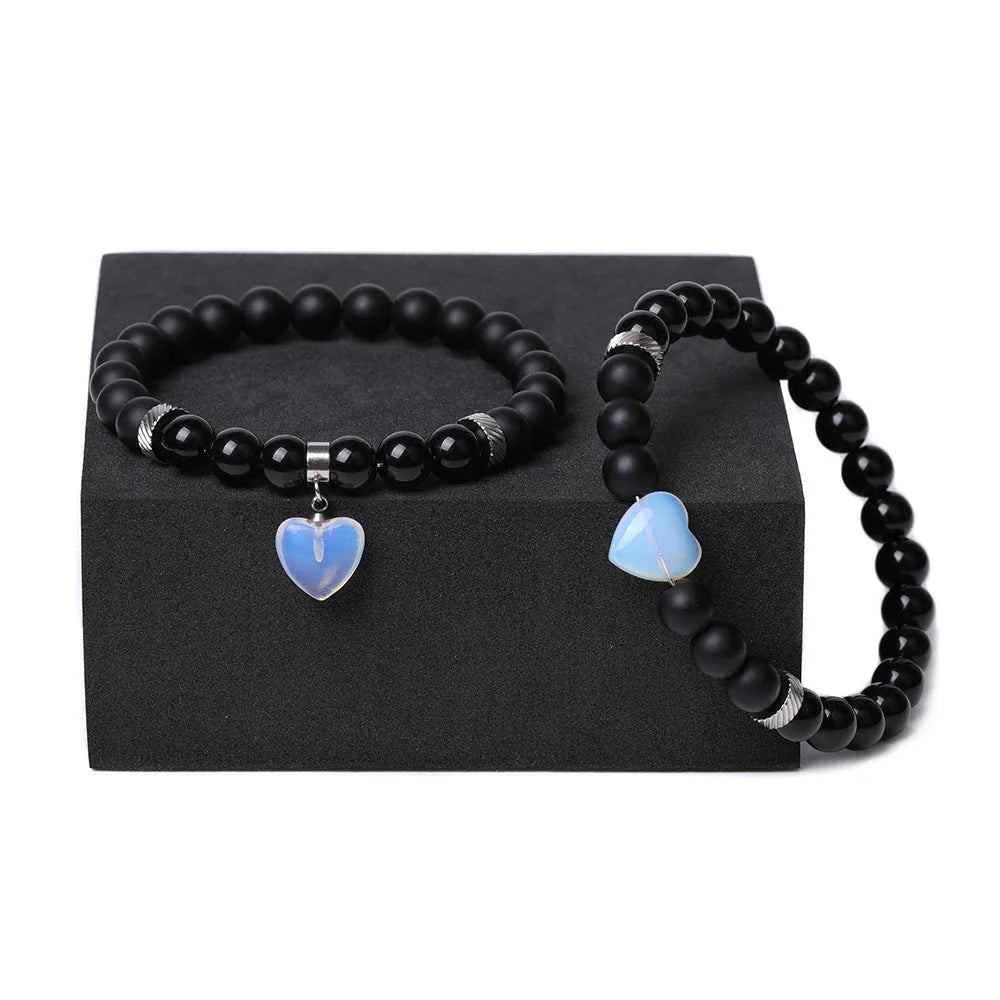Natural stone couple bracelet set showing two matching bracelets with heart-shaped polished stone charms