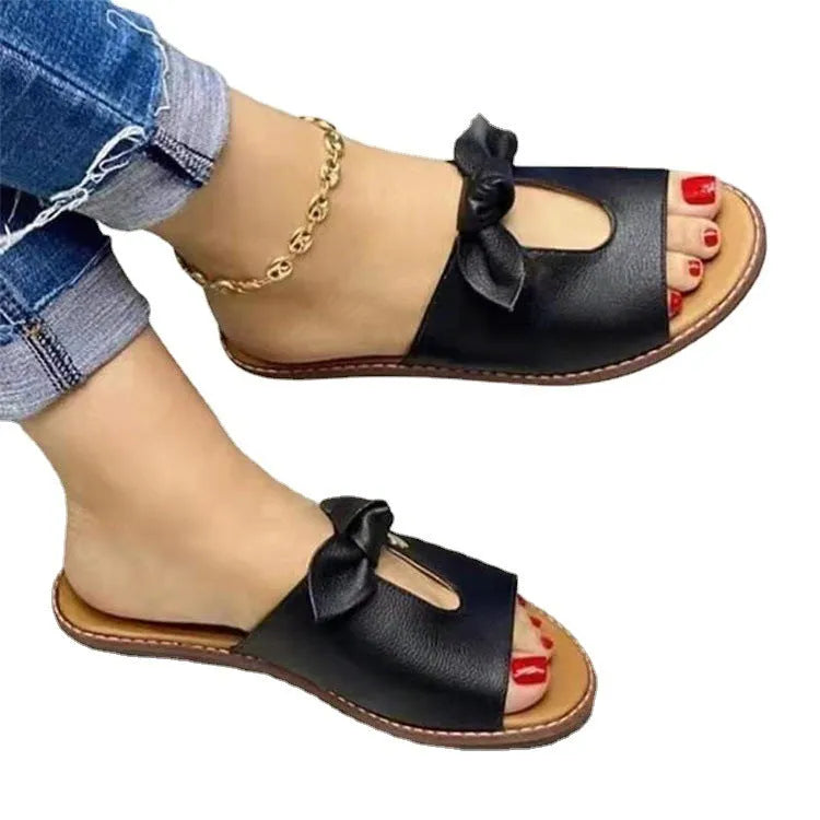 Black ladies sandals with a fish mouth design and a decorative bow on the artificial PU upper.