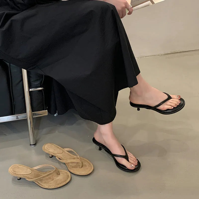 Women's rubber stiletto flip-flop sandals in black and camel colours on a white background.