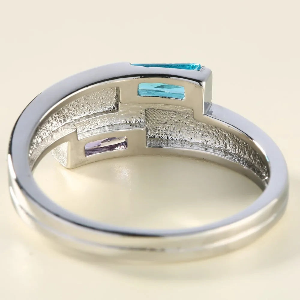 Silver colour copper electroplated ring with inlaid zircon stone on a band