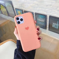 Solid colour silicone phone case for iPhone, shown in dark green, on a wooden surface.