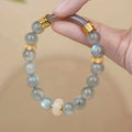 Emerald green jade bracelet with floating flower girl design in a half bracelet style.
