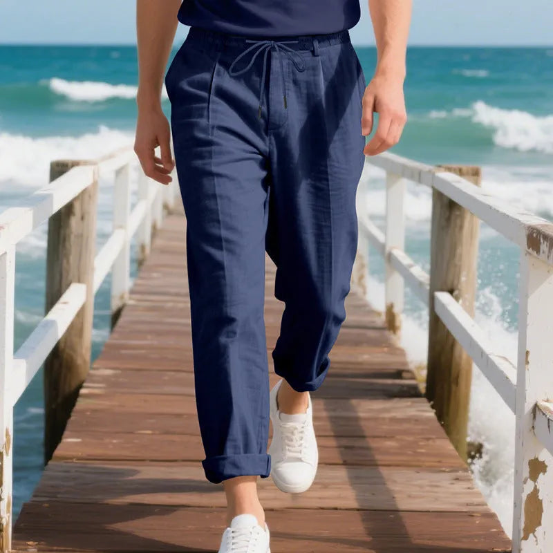 Men's light khaki linen casual trousers with a drawstring waist and straight-leg fit on a hanger.