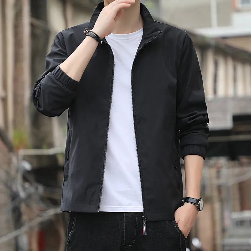 Man wearing a black Korean-style loose lapel casual jacket with zipper pockets.