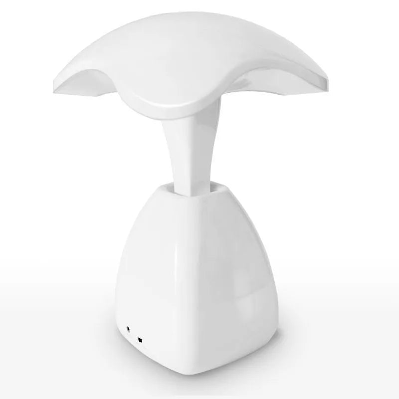 White modern plastic LED desk lamp with touch control on a wooden surface.
