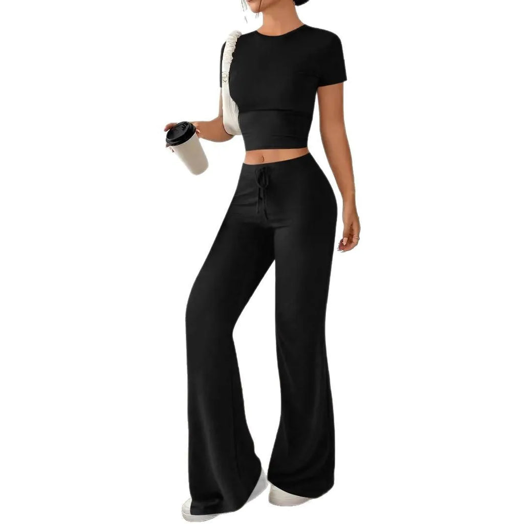 Black high waist trousers and short sleeve t-shirt matching set laid flat showing coordinated outfit