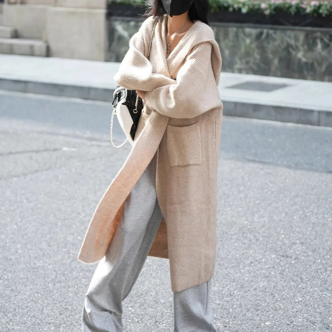 Long grey knitted hooded trench coat with a loose, cardigan-style fit and long sleeves.