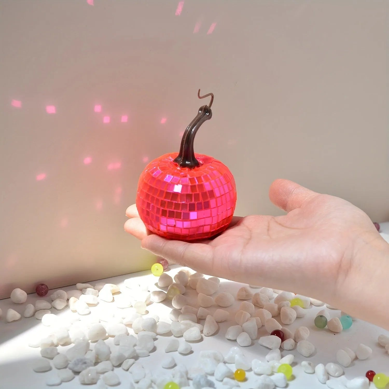 Chinese-style mirror glass pumpkin Halloween decoration in various sizes on a shelf.