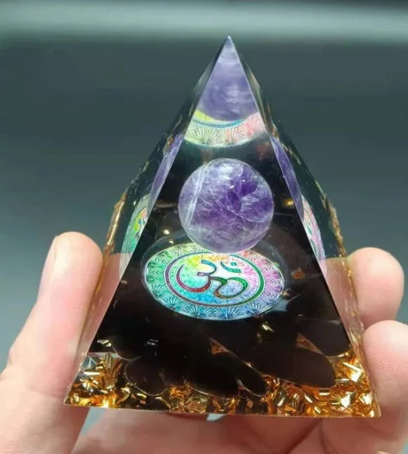 Clear epoxy resin pyramid ornament with embedded coloured crystal gravel inside, measuring 6cm.