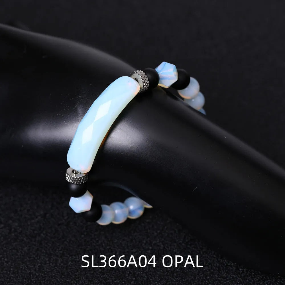 Handmade diamond-shaped cut agate bracelet in a geometric, fan-shaped design on a wrist.