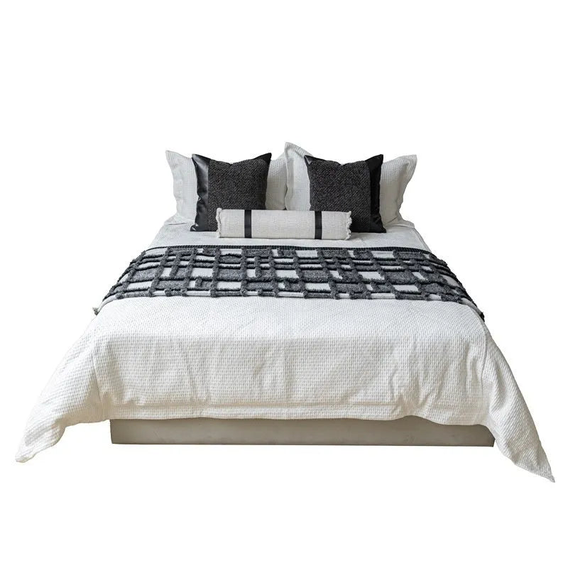 Polyester bed runner and nap blanket set with plaid pattern on bed with matching pillowcase and round pillow
