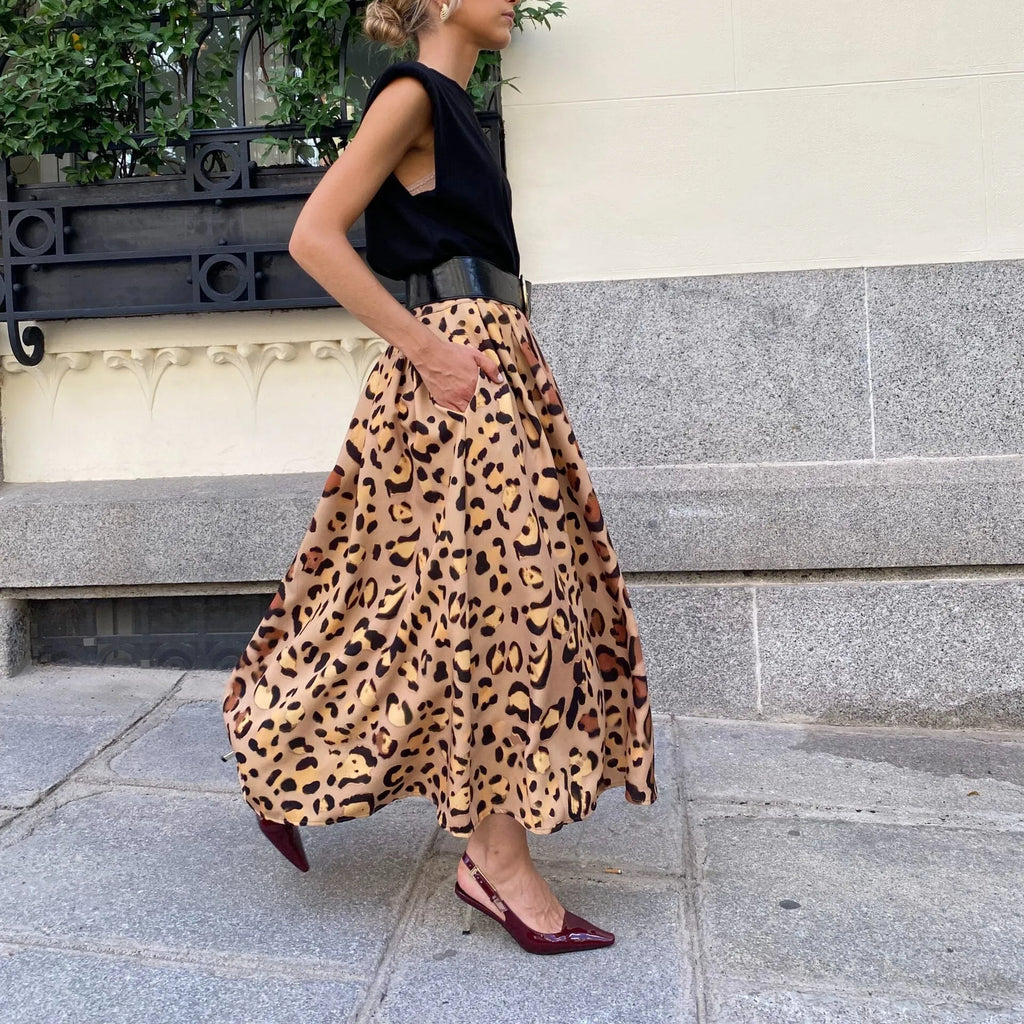 Women's brown leopard print A-line long skirt made from polyester fabric with an inelastic waist.