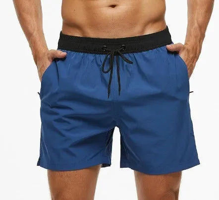 Men's blue fitness shorts with stitched waist headband, drawstring, zipper pocket, and padding for running