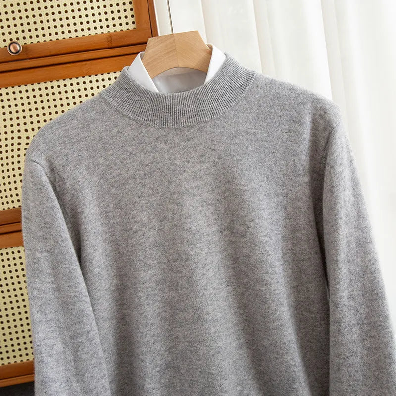 Man wearing a half-collar loose wool sweater in a textured rough yarn knit.