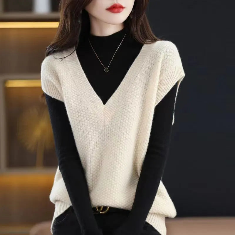 Creamy-white V-neck sleeveless knitted vest with a raised 3D pattern, laid flat.
