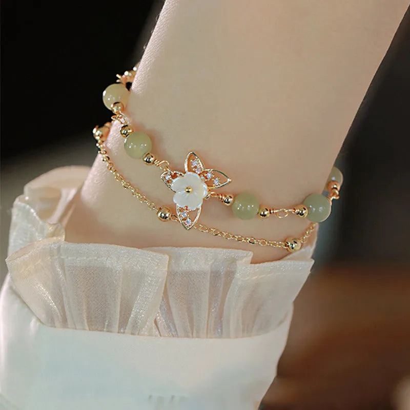 Yellow gold shell flower butterfly bracelet for women with geometric shape and bells of Ireland design