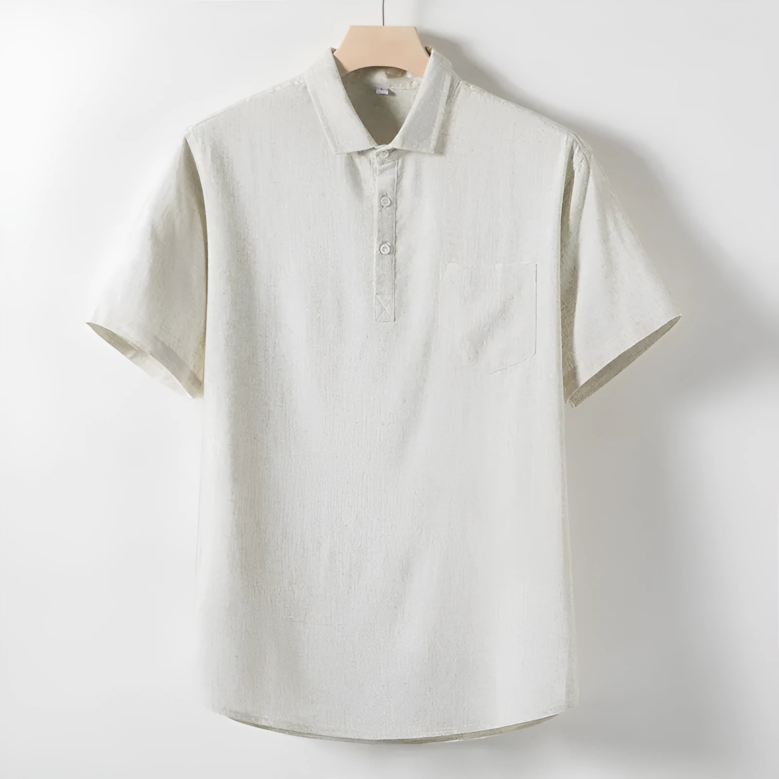 A man wearing a loose-fit linen-blend t-shirt in a solid colour with a relaxed lapel and short sleeves.
