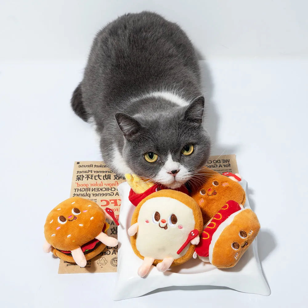 Assorted fast food shaped cat chewing toys including hamburger, chicken leg, bread, fries, and hot dog designs