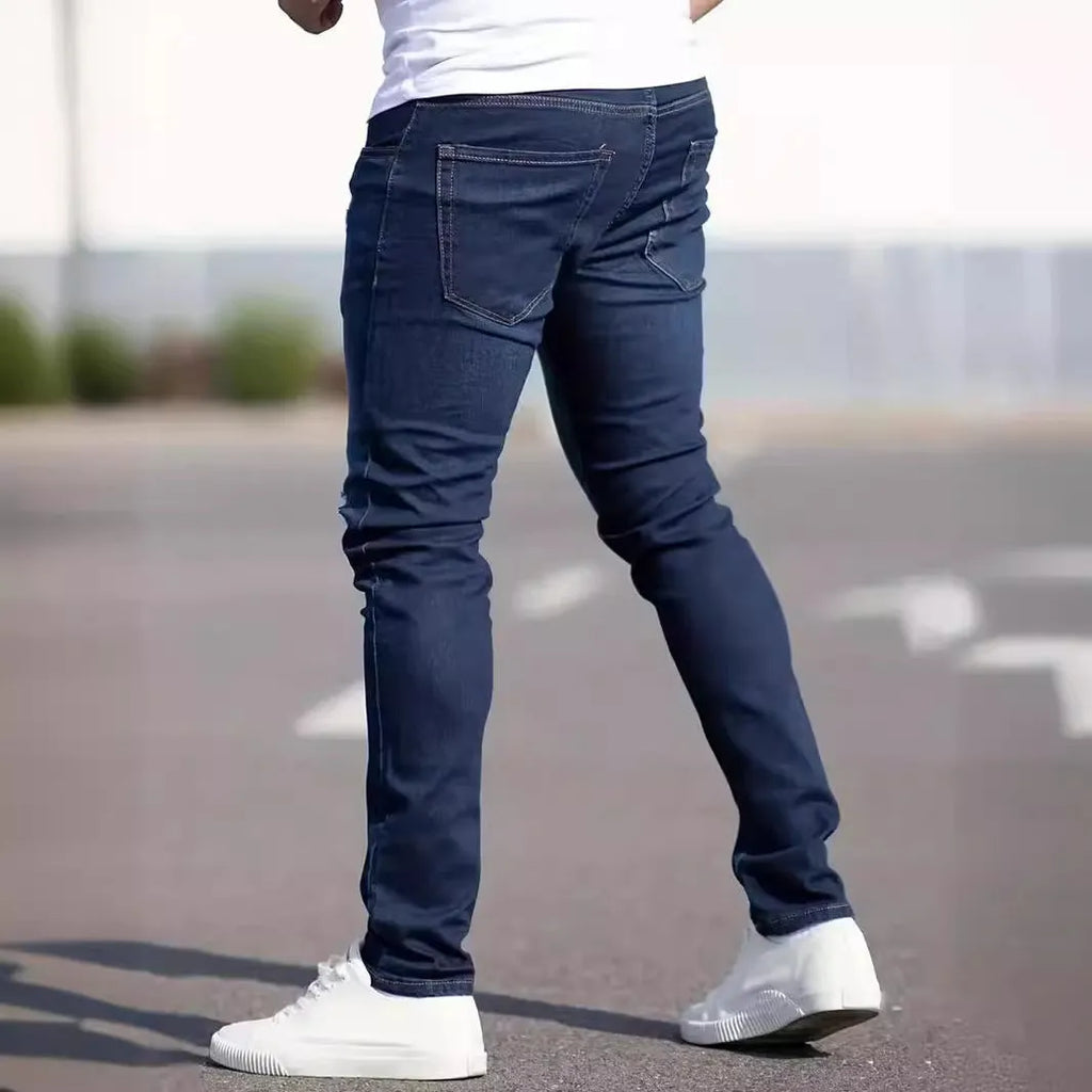 Men's dark blue slim fit casual jeans with a skinny leg and zip fly closure