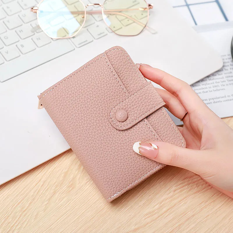 Women's short organ wallet with lychee pattern in pu leather, showing antibacterial lining and reinforced sewing thread detail