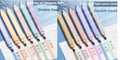 Fluorescent double-headed marking pens in mixed colour assortment with both broad and fine tips visible.