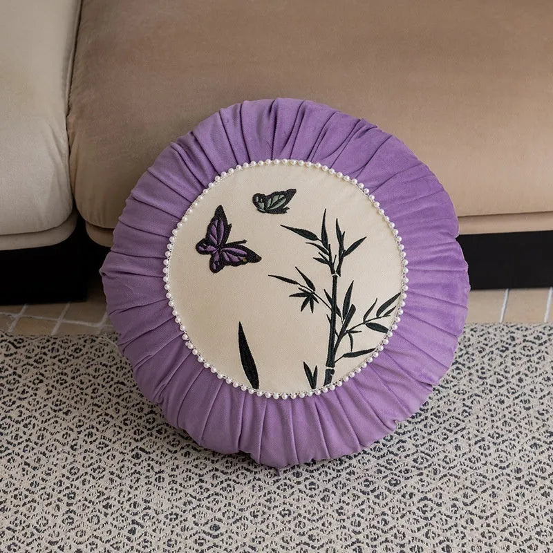 Square beige cushion with detailed black butterfly embroidery in a Chinese style pattern.