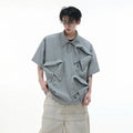 Men's loose fit deconstructed polo shirt with geometric print in black, gray, or white.