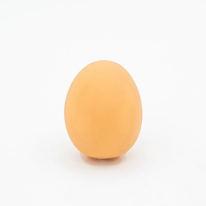 Egg-shaped dog toy with textured surface for tooth cleaning and sound feature