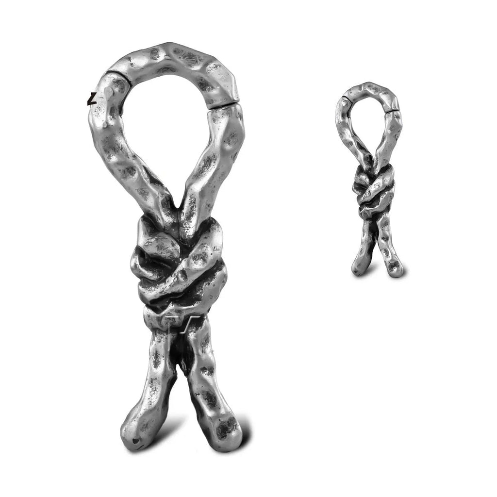 Close-up of a 4mm copper piercing earring with a bending, connecting retro shape.