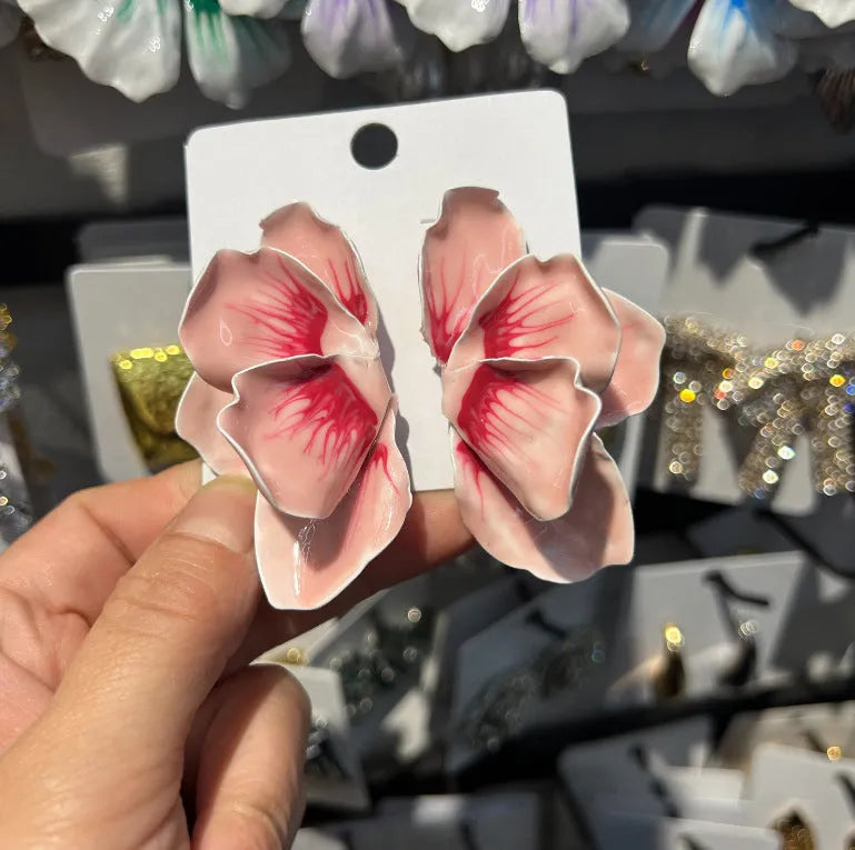 A pair of pastoral style alloy stud earrings with oil-spot glaze floral design in one of four colours.
