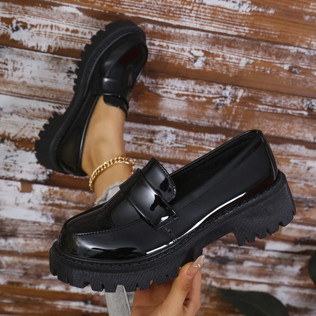 Plus size women's black slip-on loafers with a chunky mid-heel and thick rubber sole.