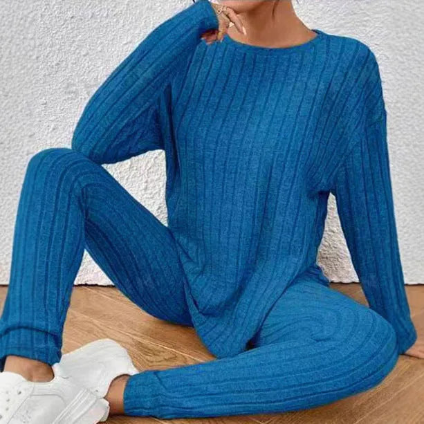 Women's black and blue sunken stripe patterned two-piece polyester homewear set with top and loose-fit pants.