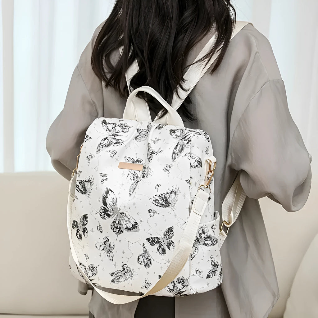 Butterfly printed PU backpack in multiple colours showing sewing line detail and curved backplate
