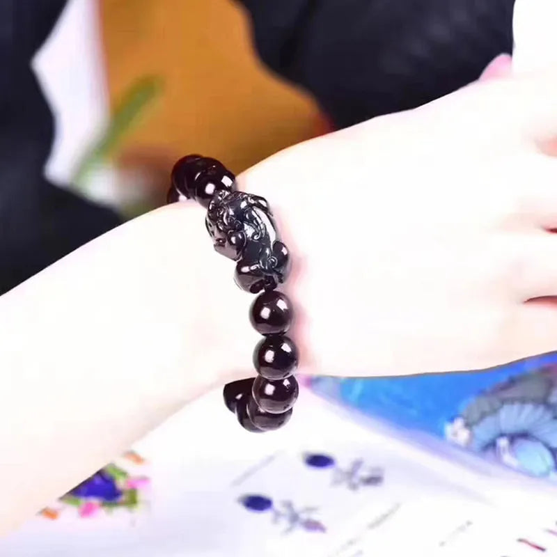 Natural ice colour Eye Obsidian crystal bracelet showing semi-translucent beads on wrist