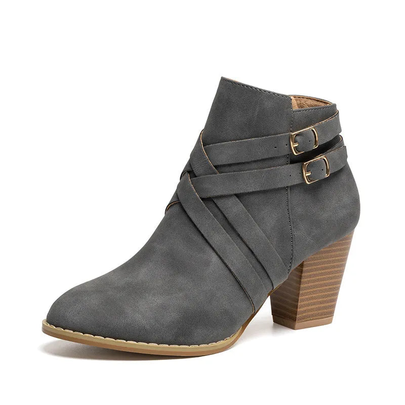 Women's grey PU leather ankle boot with a 7cm heel, side zipper, and belt buckle.