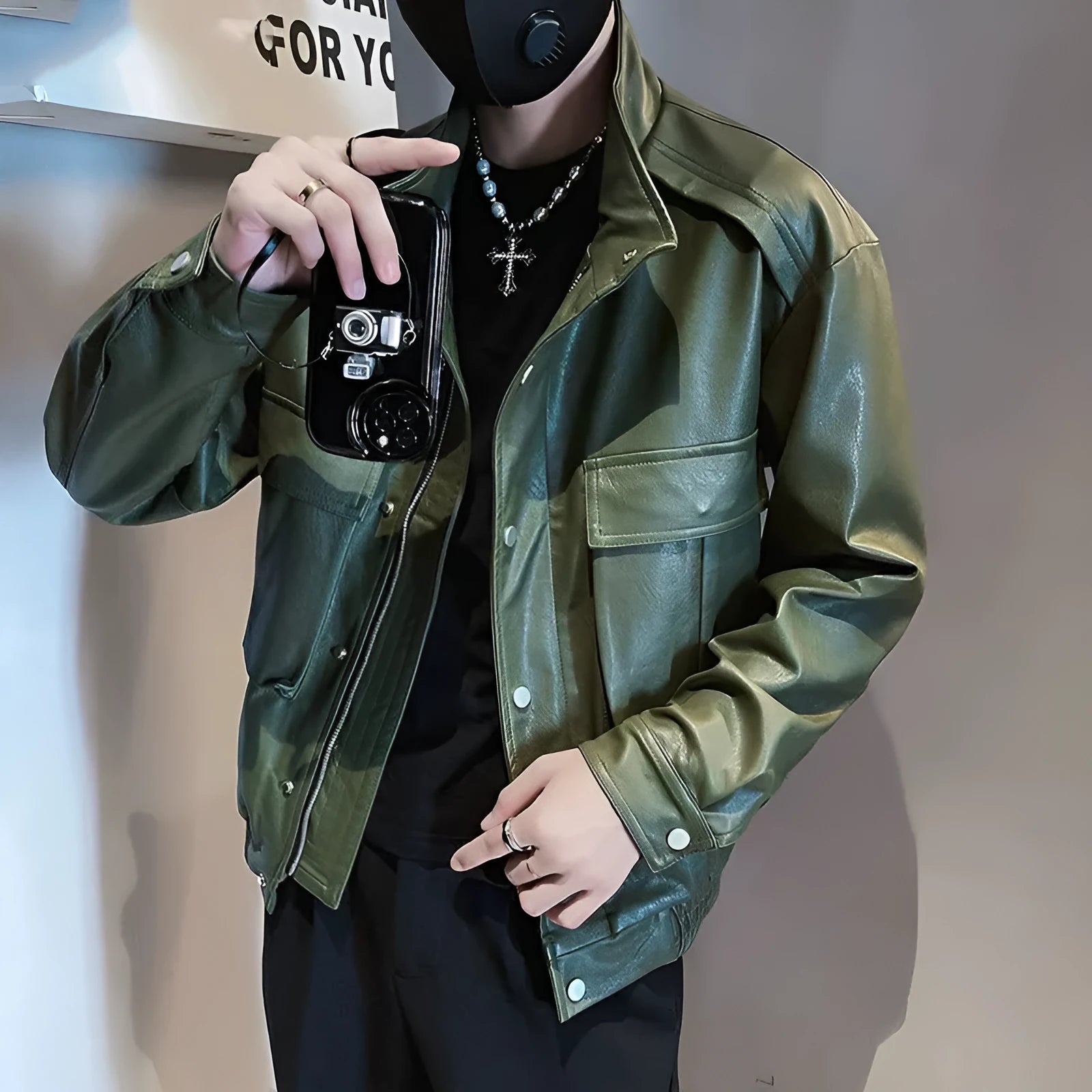 Men's black Korean style PU leather jacket with side pockets on a hanger