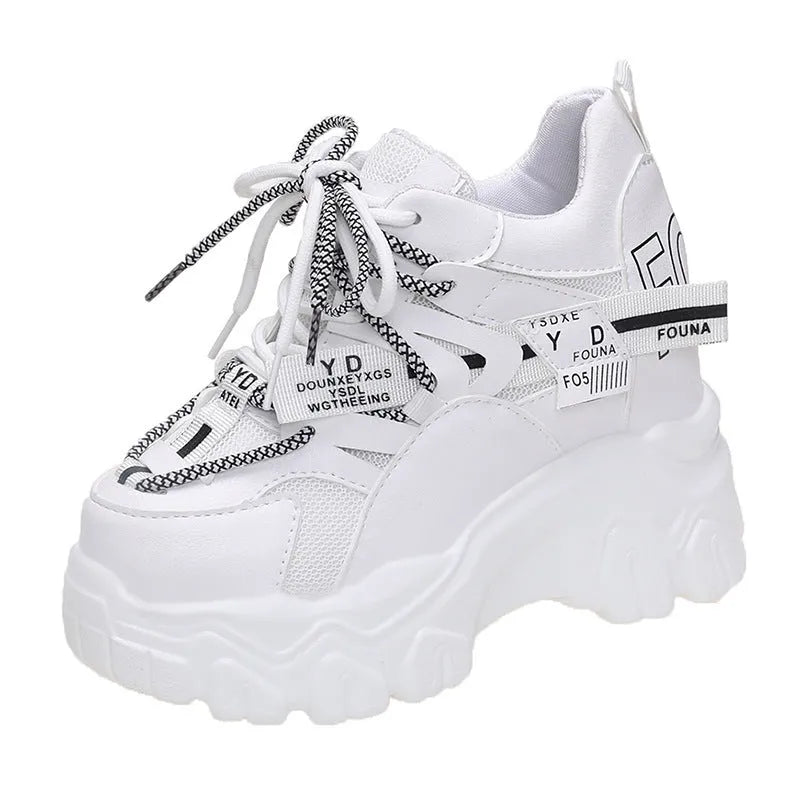 White women's low-top platform sports shoes with breathable mesh, cross strap, and rubber sole.