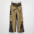 Women's high-waisted dark khaki jeans with leopard print and fake contrast stitching in a straight-leg style.