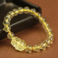 Yellow leather strap Citrine Pi Xiu bracelet with round artificial crystal beads in national folk style.