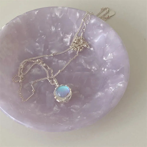 Polished sterling silver necklace for women with round geometric stone pendant on curb chain.