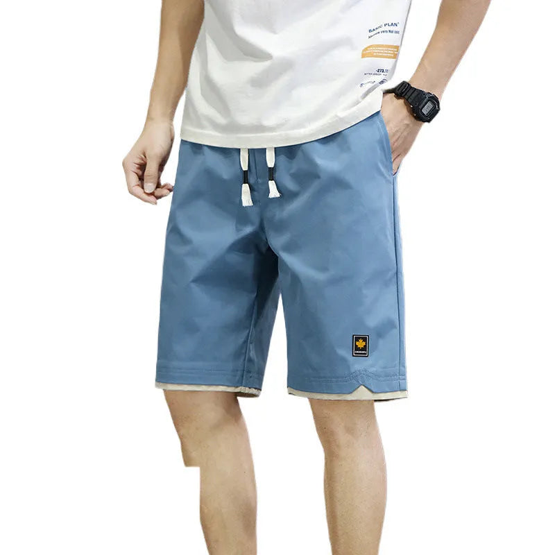 Man's loose-fitting straight-leg beach shorts in green on a neutral background.