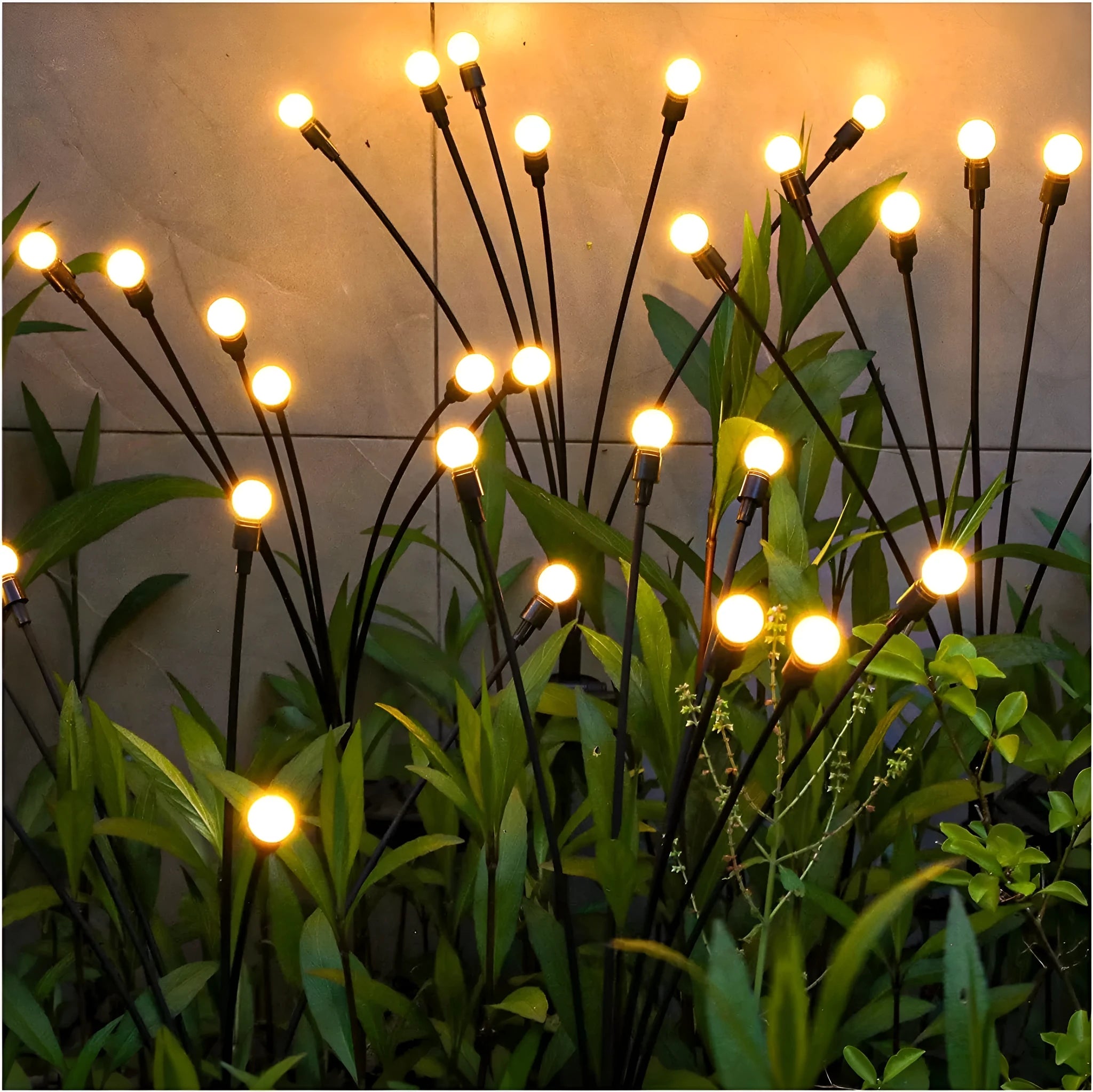 Solar-powered LED firefly lawn light with ground stake inserted in grass
