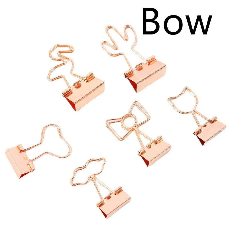 Gold-plated decorative binder clips showing flamingo, love, clouds, cat, cactus and bow designs