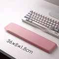 Square silicone wrist rest mouse pad with wrist strap in multiple colour options on a desk
