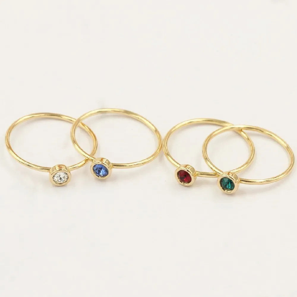 14K gold plated zircon knuckle ring on finger showing copper base with decorative stones