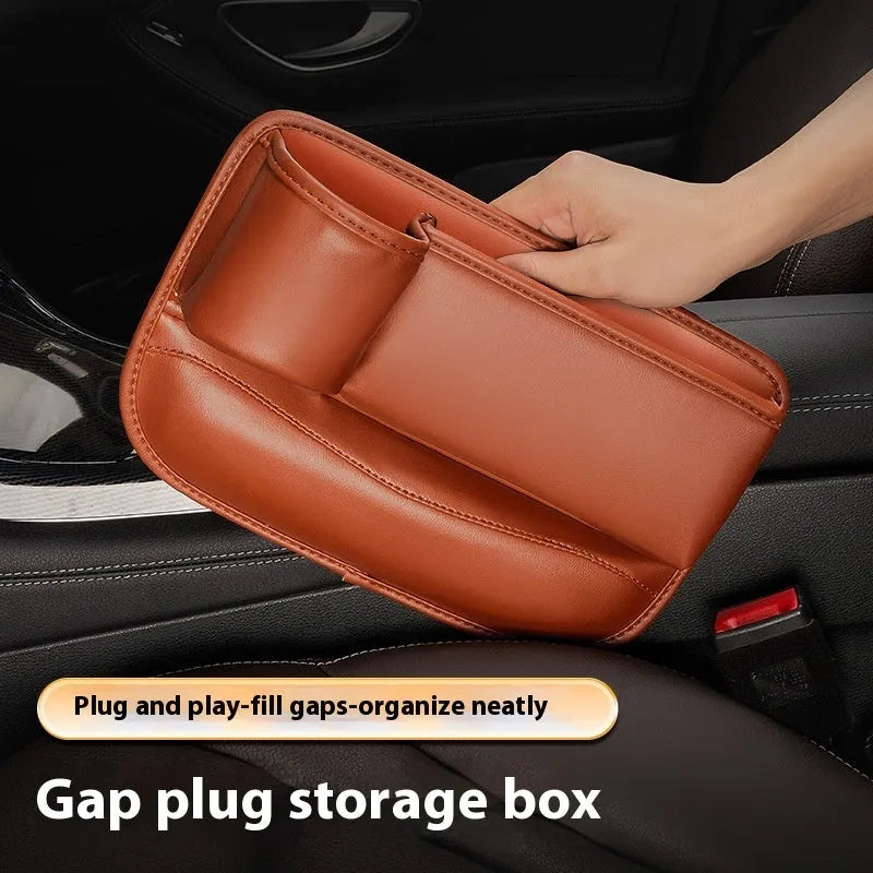 Car seat gap storage box with water cup holder in black leather beside driver seat