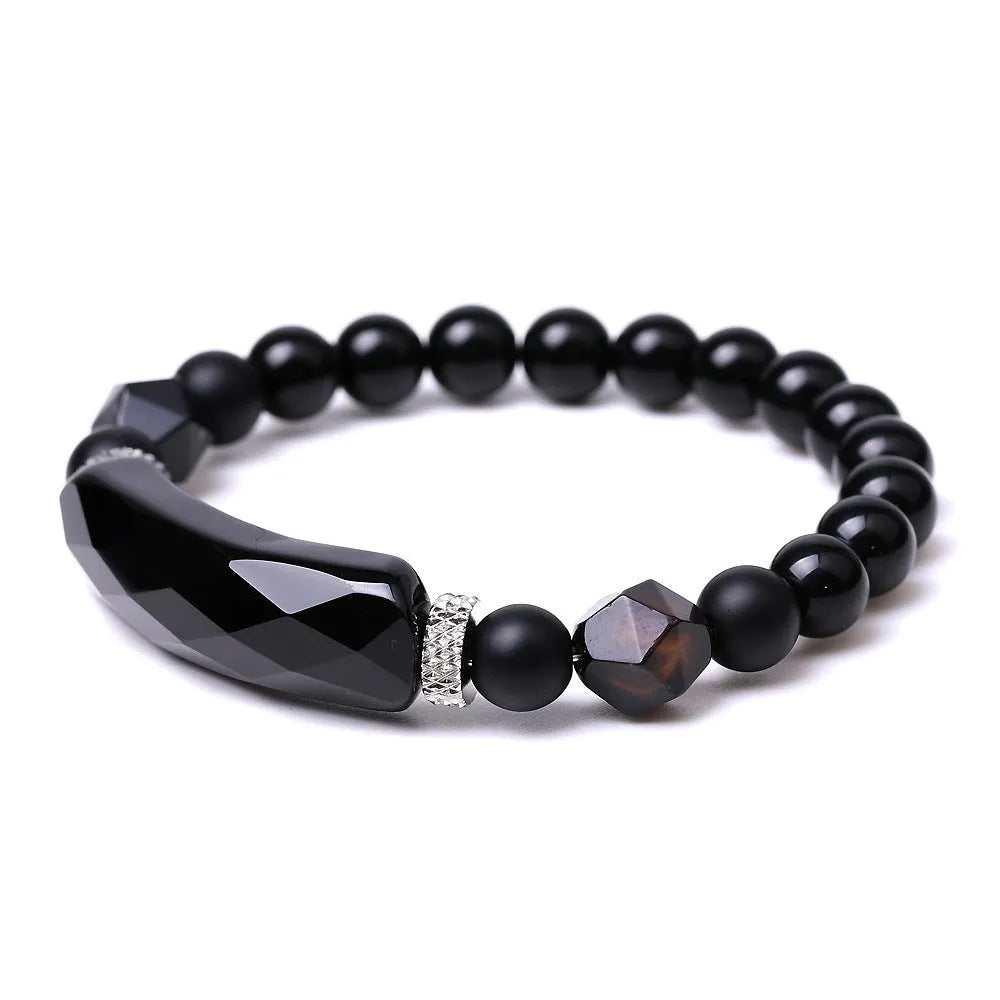 Handmade diamond-shaped cut agate bracelet in a geometric, fan-shaped design on a wrist.