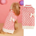 Red love heart design dog sweater on a small dog, showing acrylic knit fabric and playful motif.