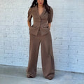 Brown men's polyester two-piece suit with slim fit waist, featuring a long-sleeved top and matching trousers.